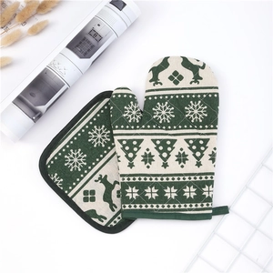 Christmas oven mitt and pot holder set with reindeer and snowflake patterns
