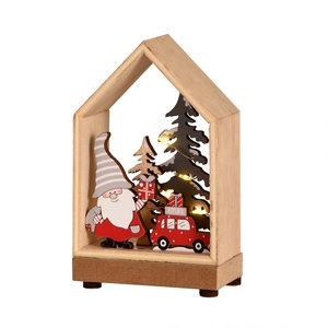 Lighted wooden Christmas house scene with Santa, red car and warm LED string lights