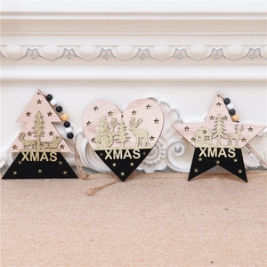 Close-up of three wooden Christmas ornaments featuring glittery deer and snowman motifs