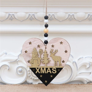 Detail of wooden heart Xmas ornament with glitter snowman and hanging beads