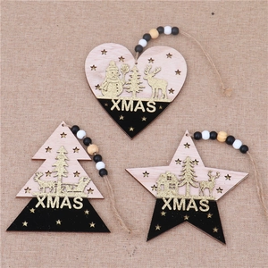 Detailed view of wood Christmas tree, heart, and star ornaments with XMAS text