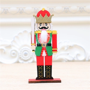 Close-up of wooden nutcracker soldier ornament with gold glitter crown and white fur beard