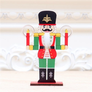 Detail of wooden nutcracker soldier ornament with laser-cut edges and festive red green colors
