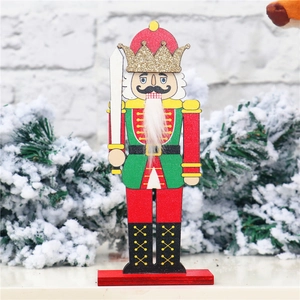 Detail of wooden nutcracker soldier with red green uniform and gold glitter crown