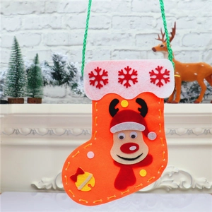 DIY Christmas felt stocking with reindeer decor and white trim on warm festive background