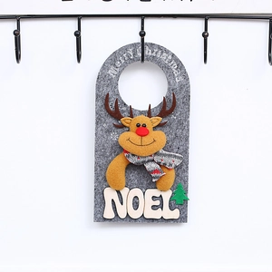 Close-up of felt reindeer ornament with Merry Christmas text and wooden Noel letters