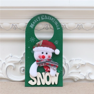 Detail of green felt Christmas door hanger with Merry Christmas text and 3D plush snowman