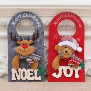 Detail of Christmas felt hanging ornaments with reindeer NOEL and bear JOY designs