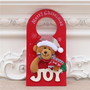 Detail of plush Christmas bear door hanger with Merry Christmas lettering on red felt