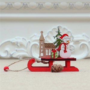 Detail of DIY Christmas wooden sled ornament with snowman and festive tree on burlap