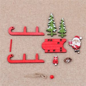 Flat lay of DIY Christmas wooden sleigh parts with Santa, trees and pine cones