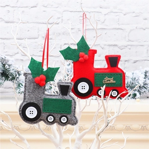 Close-up of red and grey felt car ornaments hanging on a white decorative branch