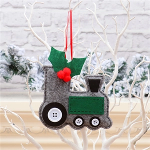 Detail view of handmade grey felt train ornament hanging on white decorative branches
