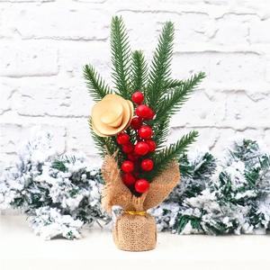 Detailed view of a 25cm mini Christmas tree with red berries and burlap base decor