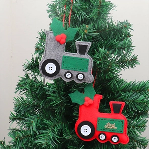 Felt Christmas train ornaments in red and grey hanging on a lush green Christmas tree