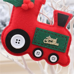 Close-up of a red felt Christmas train ornament with Merry Christmas text on branches