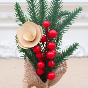 Detail of 25cm mini Christmas tree with red berries, pine needles and burlap base