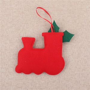 Close-up of red felt Christmas car ornament with green holly leaves and red hanging cord