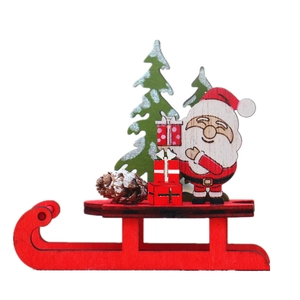 DIY colorful wooden Christmas sleigh tabletop ornament with Santa and trees on white background
