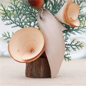 Detail view of 25cm mini Christmas tree with wooden base and burlap ribbon decor