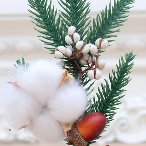 Macro shot of 25cm mini Christmas tree with white cotton, pine needles and red acorn