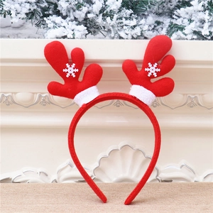 Close-up of red Christmas reindeer headband with white snowflake sequins and faux fur trim