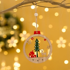 Hanging wooden Christmas tree ornament with reindeer and house cutout on festive branch