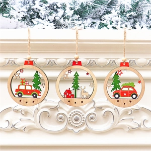 Detailed view of three carved wooden Christmas ornaments featuring red car and tree patterns