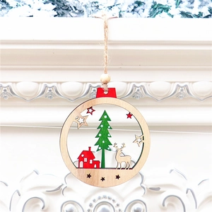 Detail of wooden Christmas ornament with a reindeer and house inside a hollow circle