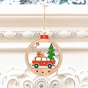 Detail of round wooden Christmas ornament with hollow-carved red car and pine tree design