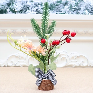 Close-up of mini Christmas tree with red berries, pine needles and checkered bow
