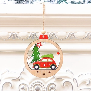 Detailed view of hollow carved wooden Christmas ornament with red car and green tree design