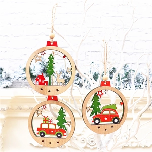 Close-up of laser-cut wooden Christmas ornaments with red car and tree designs