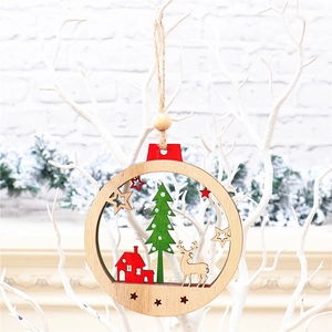 Detailed close-up of a festive wooden Christmas tree ornament with a red house and reindeer