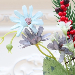 Detail of silk daisies, red berries and pine needles for Christmas home decor