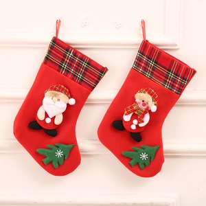 Detail of red Christmas stockings featuring 3D Santa and Snowman with plaid cuffs