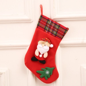 Christmas stocking with 3D Santa and plaid cuff hanging on a classic white wall background