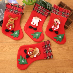 Set of four Christmas stockings with 3D reindeer and Santa appliques on wood background