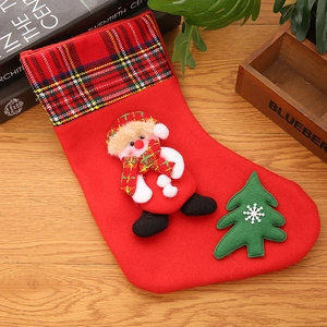 Christmas stocking detail with 3D snowman and plaid cuff on rustic wood background