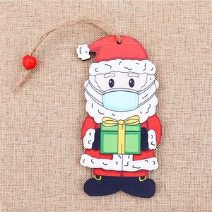 Christmas tree wooden painted Santa pendant with mask and gift on burlap background