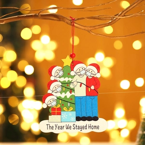 Christmas tree wooden pendant featuring a family in masks with 'The Year We Stayed Home' text