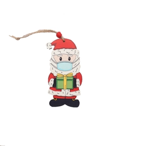 Painted wooden Christmas Santa ornament with blue mask and gift box on white backdrop