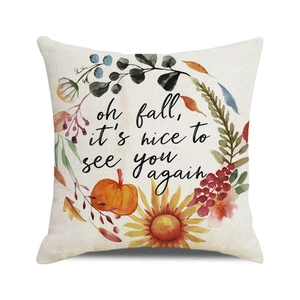 Detail of square linen pillow cover featuring watercolor pumpkin and floral autumn wreath