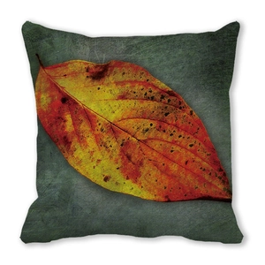 Detailed texture of peach skin fabric with realistic autumn leaf print on square cushion