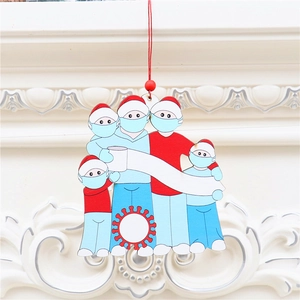 Detail of 5-member family Christmas wooden ornament with face masks on a white fireplace