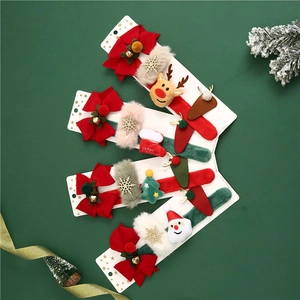 Detail of Christmas hair clip set with reindeer, Santa, and snowflake plush festive motifs