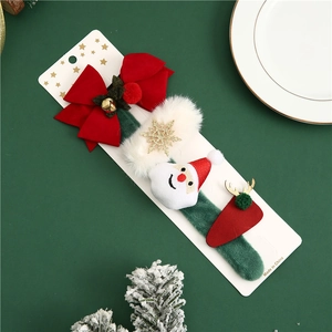 Christmas hair accessory set with Santa Claus and reindeer on a white display card