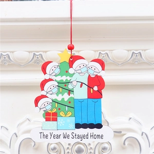 Close-up of wooden Christmas ornament with masked characters and holiday tree detail