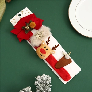Christmas hair clips set with reindeer antlers and red bows on a festive green background