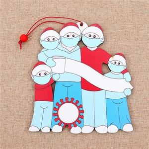 Macro view of family Christmas wooden ornament with face masks and customizable banner